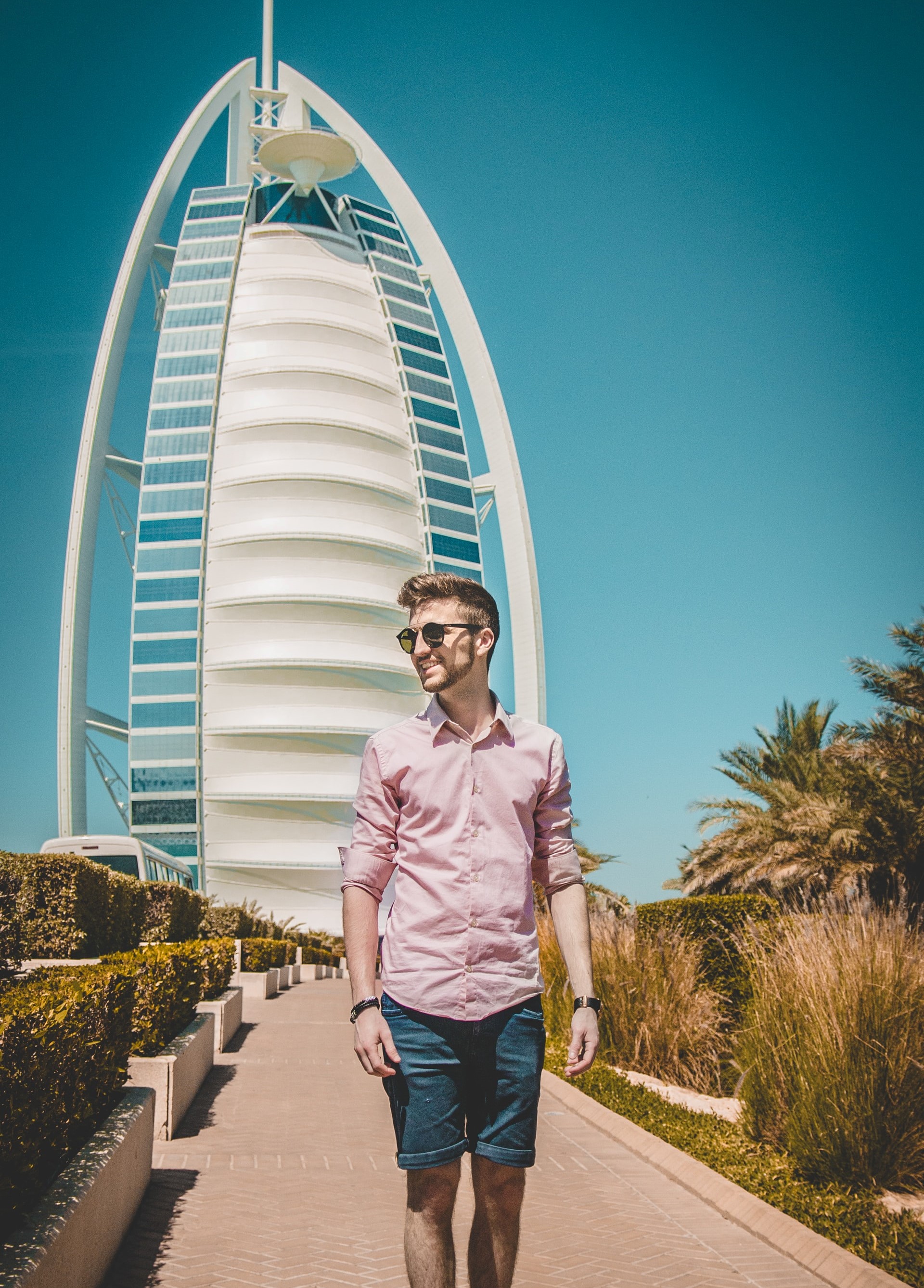 Student standing in front of a very tall skyscraper in Dubai.